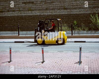 A man is driving a forklift on Krasnaya Polyana road Sochi 09/01/2018 Stock Photo