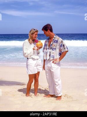 Couple on tropical beach, Grand Anse Beach, La Digue Island, Republic of Seychelles Stock Photo