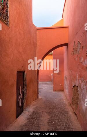 passage with Houses and orange walls in historic medina in Marrakech Stock Photo