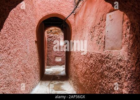 Small passage or alley in Medina in Marrakesh colored in orange Stock Photo