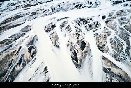 Snow masses covering huge areas of mountainous land and being moved by wind forces in chaotic landscape Stock Photo