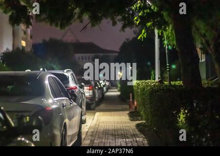 a nice looking narrow night shoot from sidewalk - there is many cars and street lights. photo has taken at izmir/turkey. Stock Photo