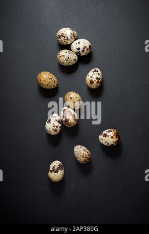 Quail eggs on a black table. Stock Photo