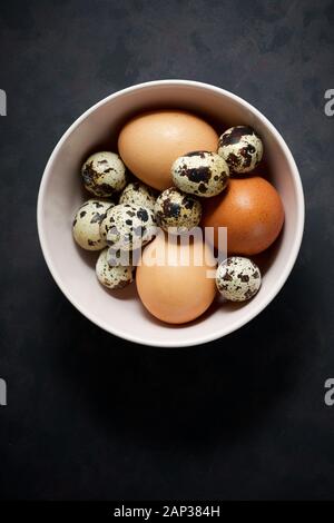 Quail and chicken eggs on a bowl. Stock Photo