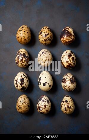 Quail eggs on a black table. Stock Photo