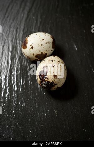 Quail eggs on a black table. Stock Photo