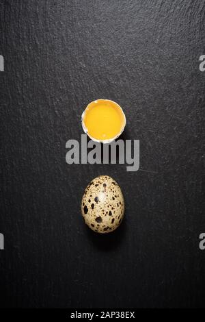 Quail eggs on a black table. Stock Photo