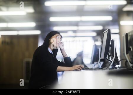 young asia woman with paper in an office working Stock Photo