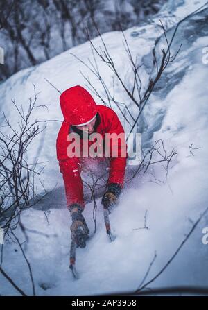 Man ice climbing on Cathedral Ledge in North Conway, New Hampshire Stock Photo