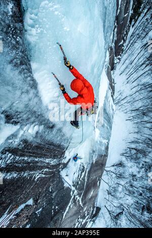 Man ice climbing on Cathedral Ledge in North Conway, New Hampshire Stock Photo