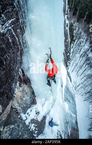 Man ice climbing on Cathedral Ledge in North Conway, New Hampshire Stock Photo