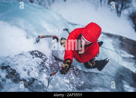 Man ice climbing on Cathedral Ledge in North Conway, New Hampshire Stock Photo