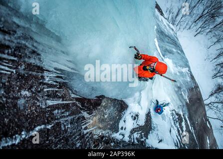 Man ice climbing on Cathedral Ledge in North Conway, New Hampshire Stock Photo