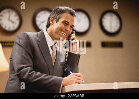 Man in suit talking on phone. Stock Photo