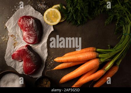 Yellowfin tuna fish with carrots, lemons and many other vegetables Stock Photo