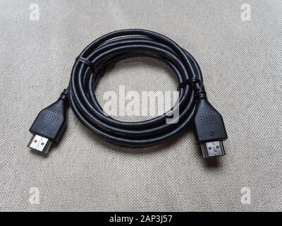 Black twisted hdmi cable for Sony PlayStation console on the table Stock Photo