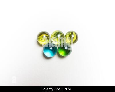 Five colored glass balls with caustics on white background Stock Photo
