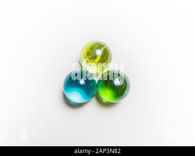 Three colored glass balls with caustics on white background Stock Photo