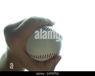 Baseball ball in male hand white background Stock Photo