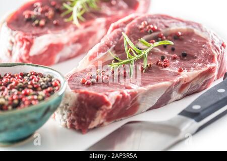 Beef Rib Eye steak with pepper and rosemary isolated on white background Stock Photo