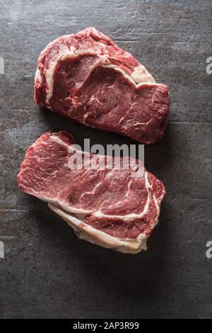 Beef Rib Eye steak on slate board - Top of view Stock Photo