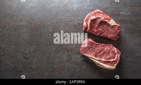 Beef Rib Eye steak on slate board - Top of view Stock Photo