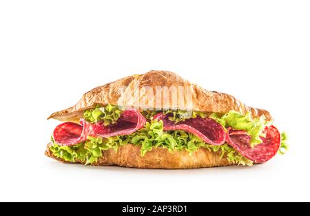 Croissant stuffed with lettuce salad and salami isolated on white background Stock Photo