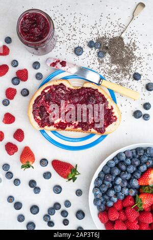 Homemade chia seed berry jam on bread with fruit and chia seeds Stock Photo