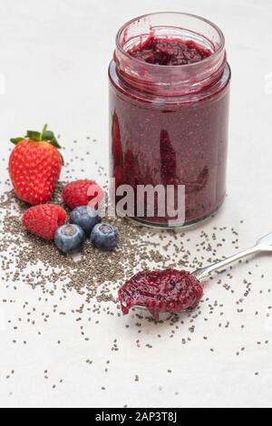 Jar of homemade chia seed berry jam with fruit and chia seeds Stock Photo