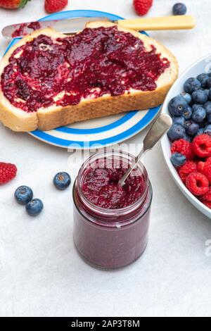 Jar of homemade chia seed berry jam with bread and fruit Stock Photo