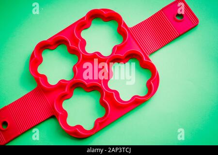 Silicone molds for baking in the form of heart and tools for baking cookies, muffins and cake on a white wooden background. Stock Photo