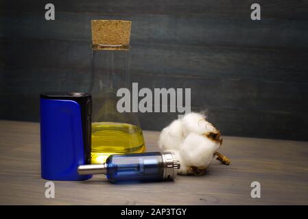 Electronic cigarette or vaping devices with natural cotton, cork stopped  flask with vape liquid Stock Photo