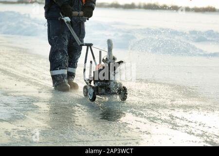 Sawing machine on the ice of a frozen lake Stock Photo