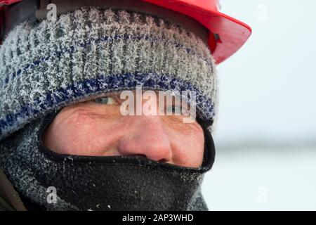 Portrait of a worker with a balaclava on his head Stock Photo