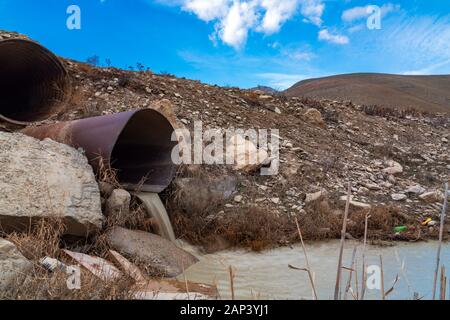 Dirty sewage from the pipe, environmental pollution Stock Photo