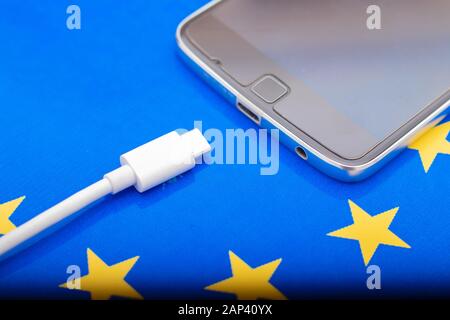 Close up Mobile phone Charger with USB Type - C cord on EU Flag Stock Photo