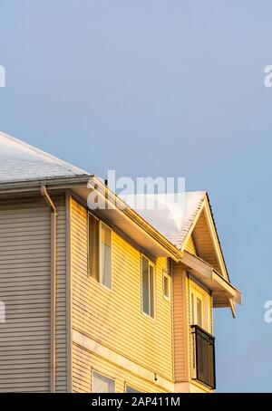 January 17, 2020 - Surrey, Canada: Rear side of large suburban home with snow covered roof in early morning. Stock Photo