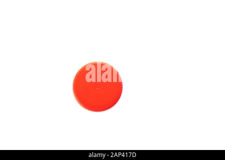 Red plastic bottle cap isolated on white background. Top view. Stock Photo