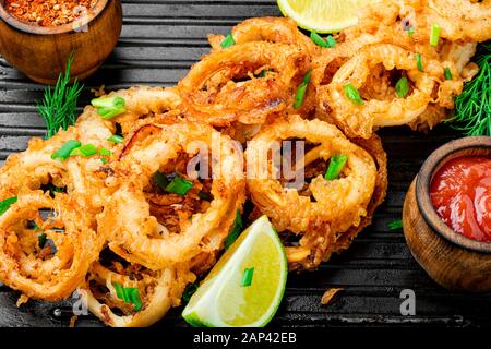Fried rings of squid in the frying pan Stock Photo
