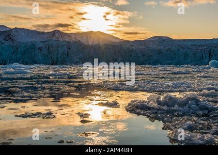 arctic glacier landscape with drift ice on ocean in sunset light - amazing polar region Stock Photo
