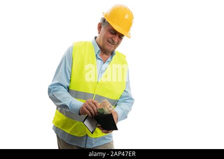 Old builder man smiling and putting money inside wallet as salary or wage concept isolated on white Stock Photo