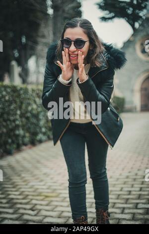 Young Brunette Turkish woman telling a smoething with hand gesture Stock Photo