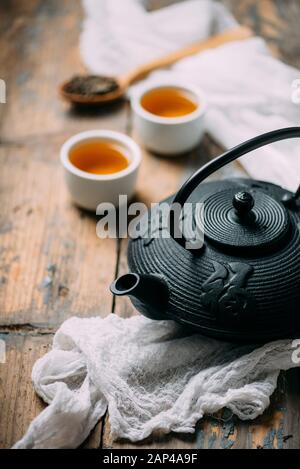 Traditional japanese herbal tea recipe prepared in cast iron teapot with organic dry herbs. Alternative medicine. Healthy asian green tea in tea pot o Stock Photo