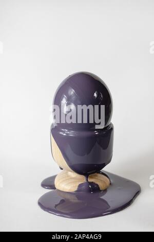 Egg daubed with paint, Easter artistic decoration. Flowing liquid dense paint. Stock Photo