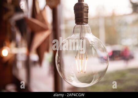 Edison retro glass lamp included light, in background cardboard star, loft style Stock Photo