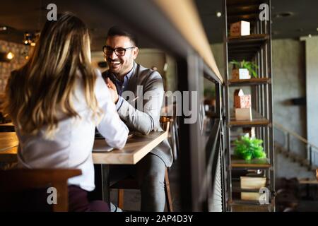 Happy romantic smiling people having date in restaurant. Couple in love. Stock Photo