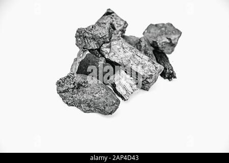 Pieces black coal lie on white isolated background, copy space Stock Photo