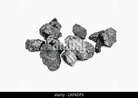 Pieces black coal lie on white isolated background, copy space Stock Photo