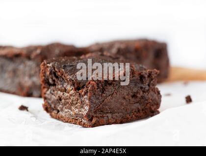 close up plant based vegan chocolate brownies made from sweet potatoes selective focus for copy space on a white background Stock Photo