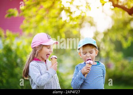 Happy child eating ice cream outdoors in summer Stock Photo
